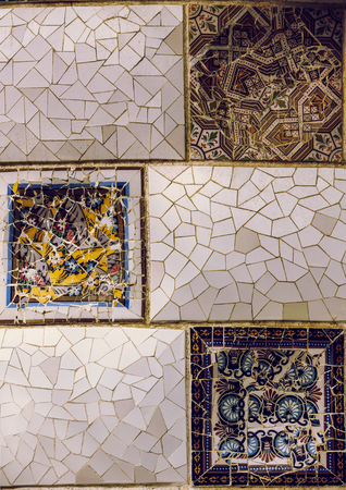 close up detail of a Geometric mosaic of ceramic tile by Antoni Gaudi at his Parc Guell, Barcelona,...