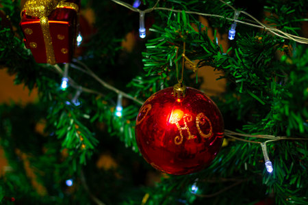 Close up of decorations on a Christmas tree with lights on. Selective focus.の写真素材