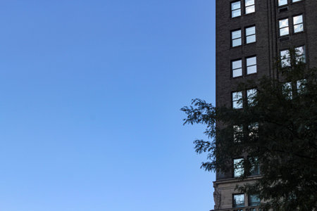 Backlit building with a cloudless blue sky.の写真素材