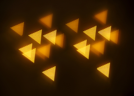 beautiful gold bokeh with pattern of geometric elements on a dark background