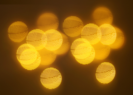 beautiful gold bokeh with pattern of geometric elements on a dark backgroundの写真素材