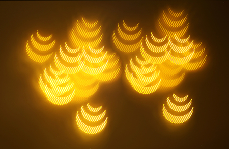 beautiful gold bokeh with pattern of geometric elements on a dark backgroundの写真素材