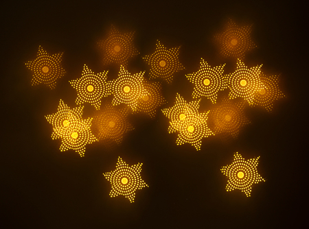 beautiful gold bokeh with pattern of geometric elements on a dark background