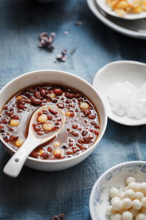 a bowl of sweet red bean soup with mini tang yuanの写真素材
