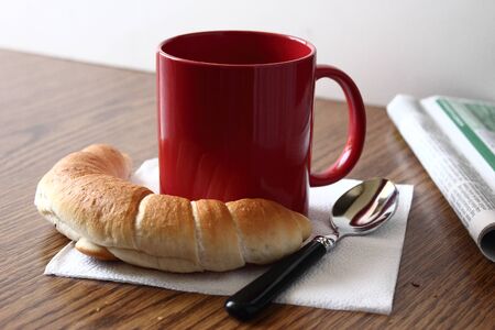 Cup of coffee, with some fresh bread.の写真素材