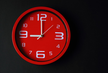 Modern black background with red clockの写真素材