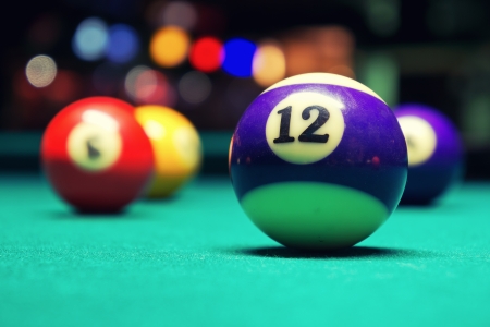 A Vintage style photo from a billiard balls in a pool table  Noise added for a film effectの写真素材