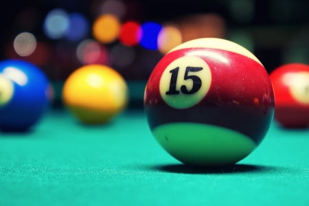 A Vintage style photo from a billiard balls in a pool table  Noise added for a film effectの写真素材