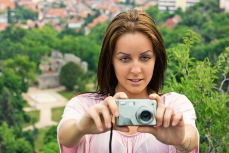 Beautiful young woman take a photo from a heightの写真素材
