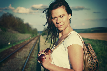 Vintage style photo from a young women waiting for the trainの写真素材