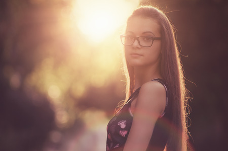 Outdoor photos of beautiful young women from sunset in the backgroundの写真素材