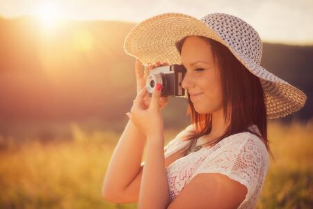 Attractive women with a vintage cameraの写真素材