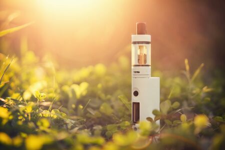 Adjustable electronic cigarette, carcinogenic alternative for Non smoking, sunset in the background,の写真素材