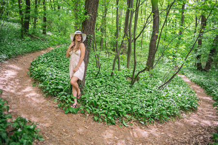 Young girl in the deep forest at flowering in springの写真素材