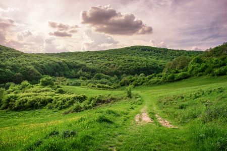 Beautiful cloudscape over the hill with sunlightの写真素材