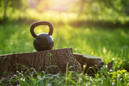 Outdoor photos from the kettlebell in the park, sunset in the backgroundの写真素材
