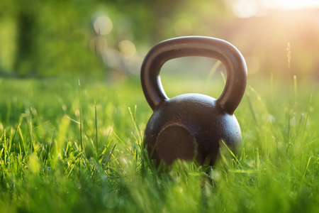 Outdoor photos from the kettlebell in the park, sunset in the backgroundの写真素材