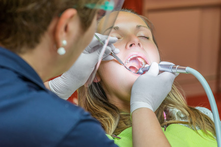 Young woman under treatment in the dentistの写真素材