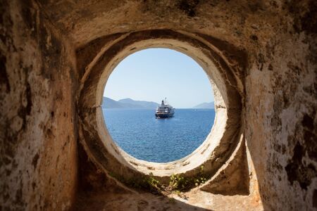 View trough window for the old sea with the shipの写真素材