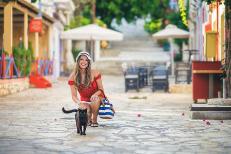 Young woman with her cat in Fiscardo, Kefalonia, Greeceの写真素材