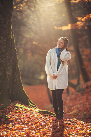 Young woman hiking in the forest at autumnの写真素材