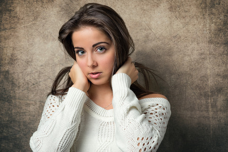 Beautiful young woman on vintage backgroundの写真素材