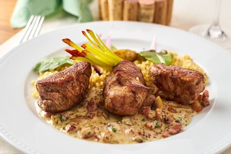 Roasted pork with ragout and bulgur dionの写真素材