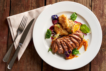 Ros? duck breast with hungarian potato dumplings, baked apple-beetroot cream and orange-pumpkin marmaladeの写真素材