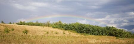 Summer landscape with a rainbowの写真素材