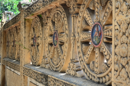 Wall sculpture around a buddhist temple in Phnom Penh, Cambodia.の写真素材