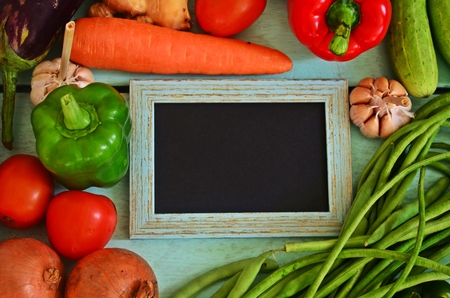Fresh vegetables and a frame in a turquoise background.の写真素材