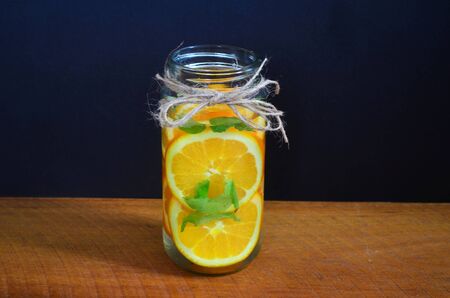 Orange detox water in a black background.の写真素材