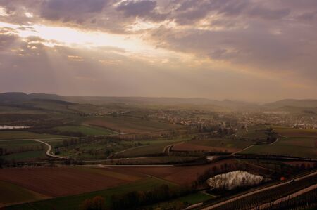 Sunbeams struggle through the clouds in the mountainsの写真素材