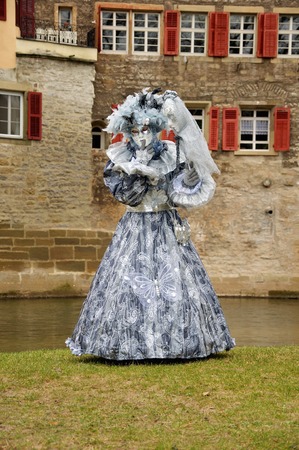 A woman on a river in a costume from Veniceの写真素材