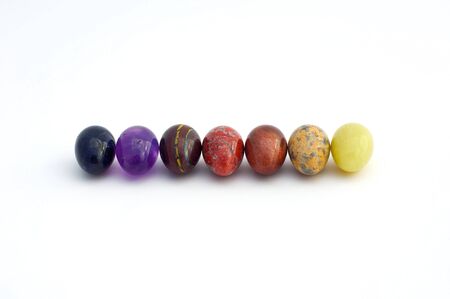 Small Easter eggs made ââof precious stones in a row isolated on whiteの写真素材