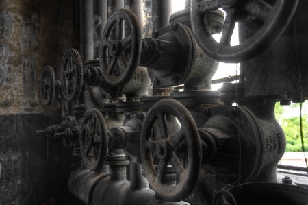 Old broken valves on pipes in a factory