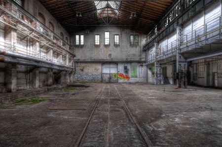 Old hall with a gate for locomotives with rails