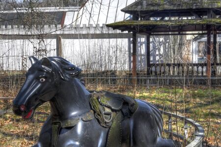 Old horse on tracks in an abandoned amusement parkの写真素材