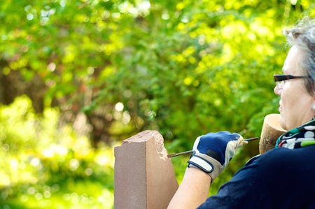 Female stonemason at work in the gardenの写真素材