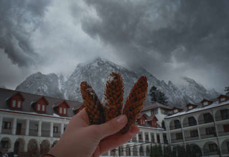 Hand-held 3 cones behind with mountains, fog clouds, Romaniaの写真素材