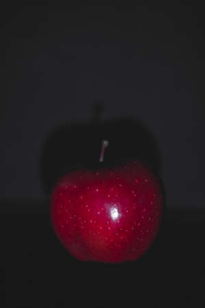 Apple fruit, abstract shadow, black background, red appleの写真素材