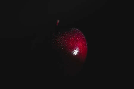 Apple fruit, abstract shadow, black background, red apple, drops of waterの写真素材