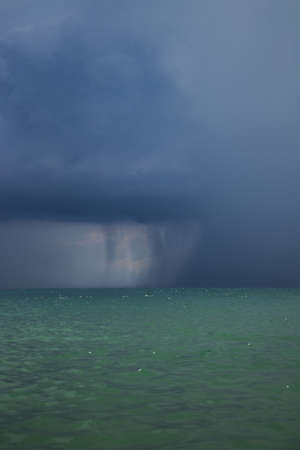 Mediterranean Sea with powerful storm in the background, light blue transparent water