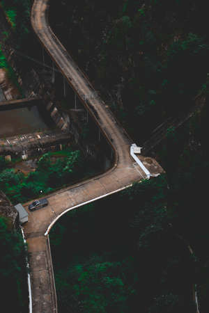 Road surrounded by green nature, aerial drone, above view