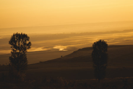 Sunrise landscape, colorful warm cold nature, world, river, hills and village, sunlightの写真素材