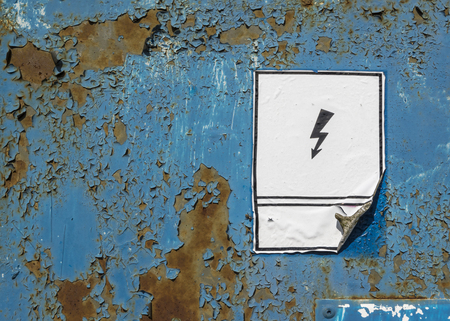 Warning sign on old coroded metal texture