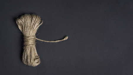 Skein of brown hemp twine isolated on black backgroundの写真素材