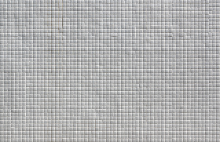 Wall covered in small white tiles textureの写真素材