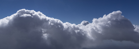 White cumulus clouds seen from top of volcanoの写真素材