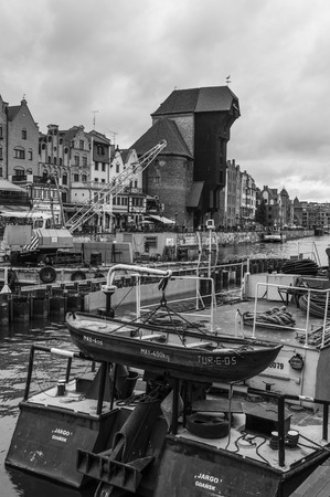 Gdansk, Poland - April 28, 2019: Old, medieval crane over Motlawa River. Symbol of Gdansk. In front...